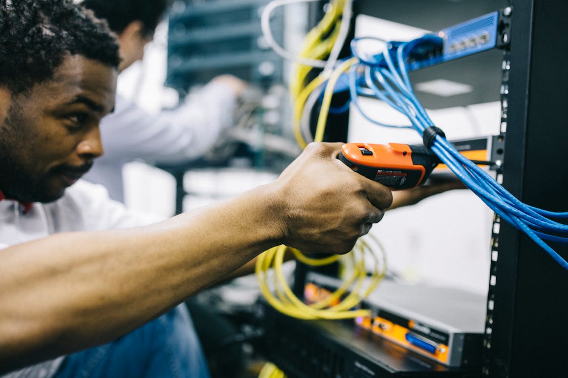 TCG team performing fiber optic installation in a Michigan facility